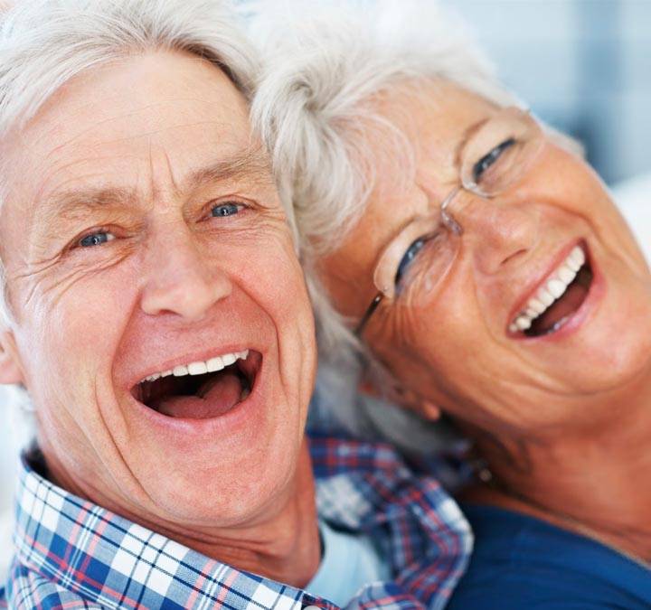 smiling_couple An close up of an elderly couple smiling happily at the camera.