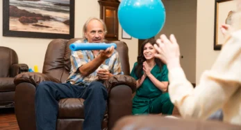 A memory care resident and caregiver enjoying a game designed to enhance cognitive skills and quality of life.