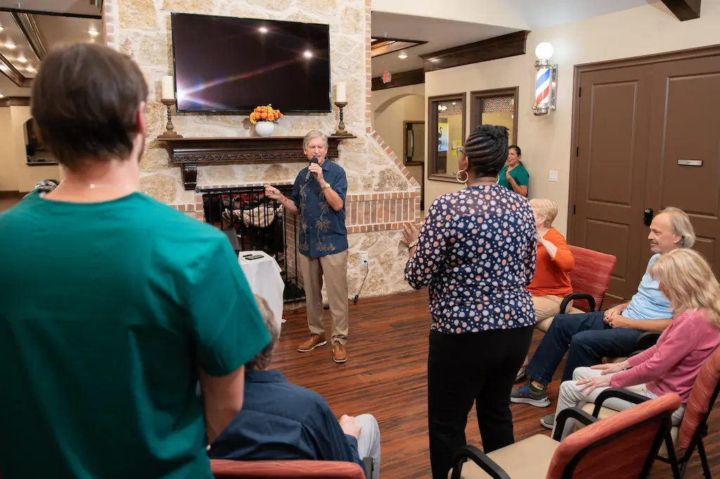 Memory care resident participating in karaoke activity at Avalon Memory care.