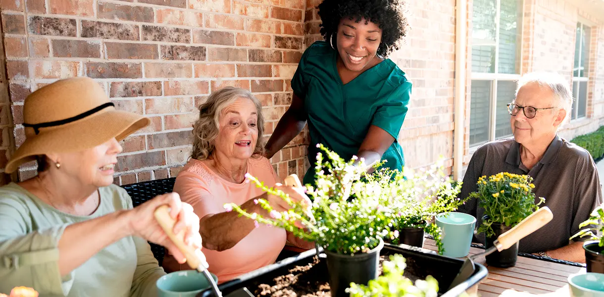 group of seniors gardening at avalon memory care